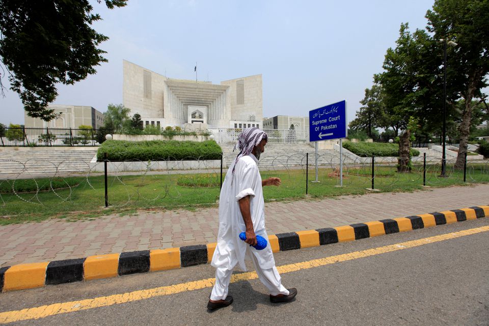 FILE PHOTO: A man walks past the Supreme Court building in Islamabad, Pakistan, June 27, 2016. REUTERS/Faisal Mahmood/File Photo
