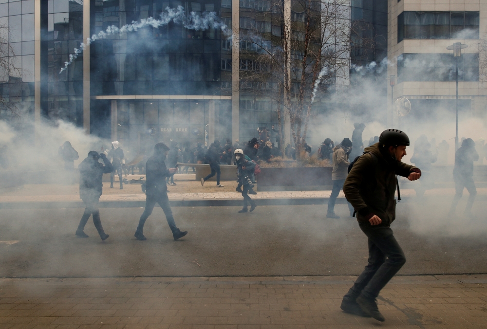 Protesters react during a demonstration against the Belgian government's restrictions imposed to contain the spread of the coronavirus disease (COVID-19) in Brussels, Belgium, January 23, 2022. REUTERS/Johanna Geron