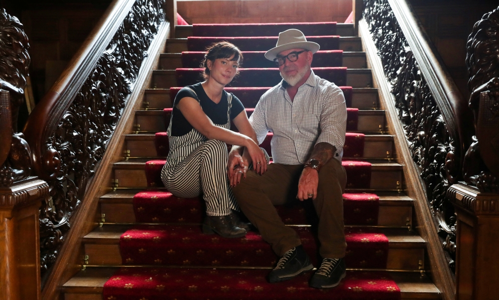 American property developers and conservationists Camille and Christopher Bently pose for a portrait on a staircase at their Kildrummy Estate, Scotland, Britain, September 7, 2021. Reuters/Russell Cheyne