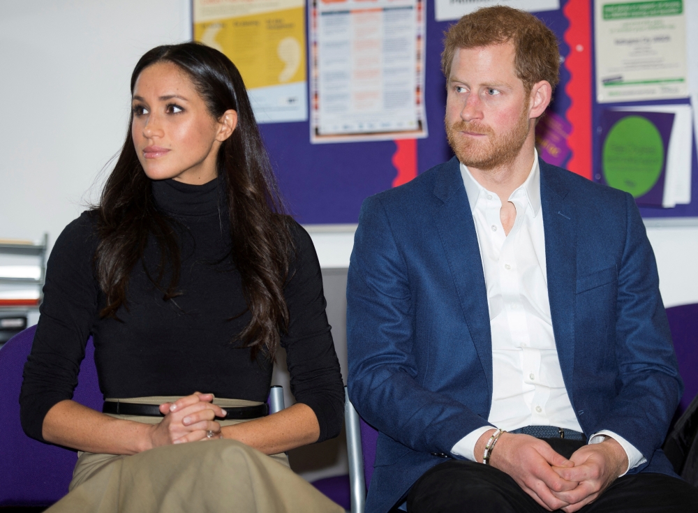 Britain's Prince Harry and his fiancee Megan Markle visit Nottingham Academy in Nottingham, Britain, December 1, 2017. REUTERS/Andy Stenning/Pool/File Photo