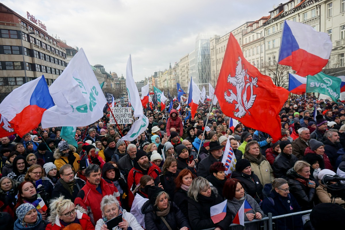 Demonstrators wave flags during a protest against Czech government's restrictions imposed to contain the spread of the coronavirus disease (COVID-19) in Prague, Czech Republic January 30, 2022. REUTERS/Jiri Skacel
