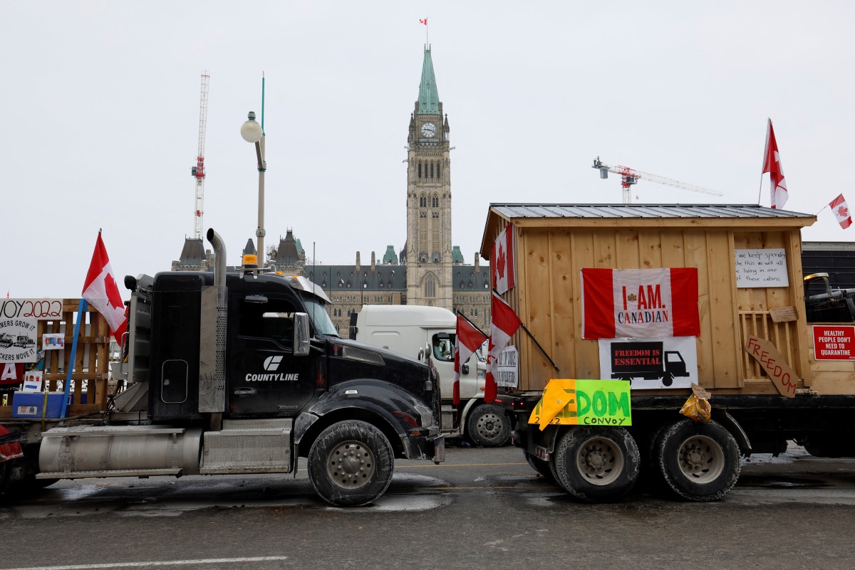 Vehicles displaying protest signs are seen outside Parliament Hill, as demonstrations by truckers and their supporters against the coronavirus disease (COVID-19) vaccine mandates continue, in Ottawa, Ontario, Canada, January 31, 2022. REUTERS/Blair Gable
