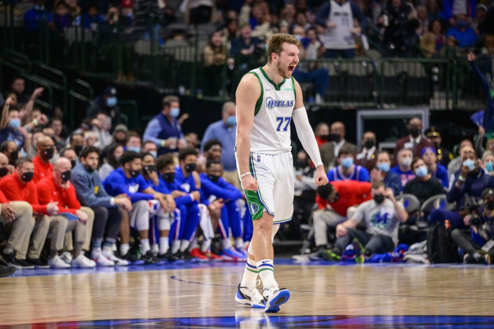 Dallas Mavericks guard Luka Doncic (77) celebrates during the second half against the Philadelphia 76ers at the American Airlines Center. Mandatory Credit: Jerome Miron
