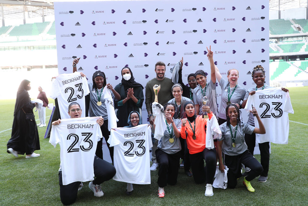 H E Sheikha Hind bint Hamad Al Thani, Vice Chairperson, CEO of Qatar Foundation and football icon David Beckham, and the winners of inaugural tournament of Women and Girls Football Initiative at Education City Stadium, yesterday. 
