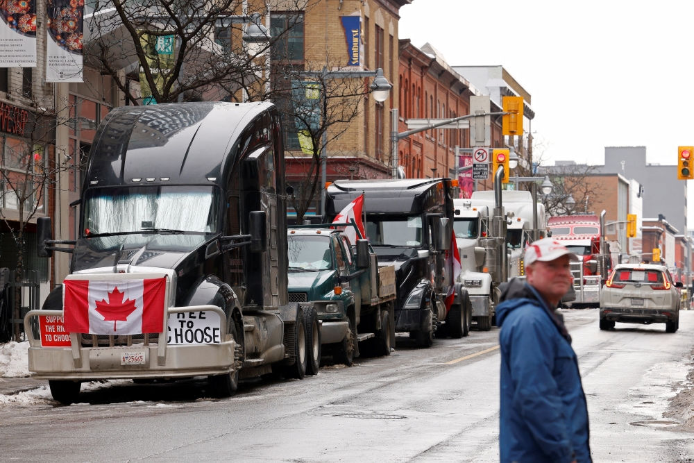 Vehicles queue on Bank Street as truckers and supporters continue to protest Covid-19 vaccine mandates, in downtown Ottawa, Ontario, Canada, February 9, 2022. Reuters/Blair Gable