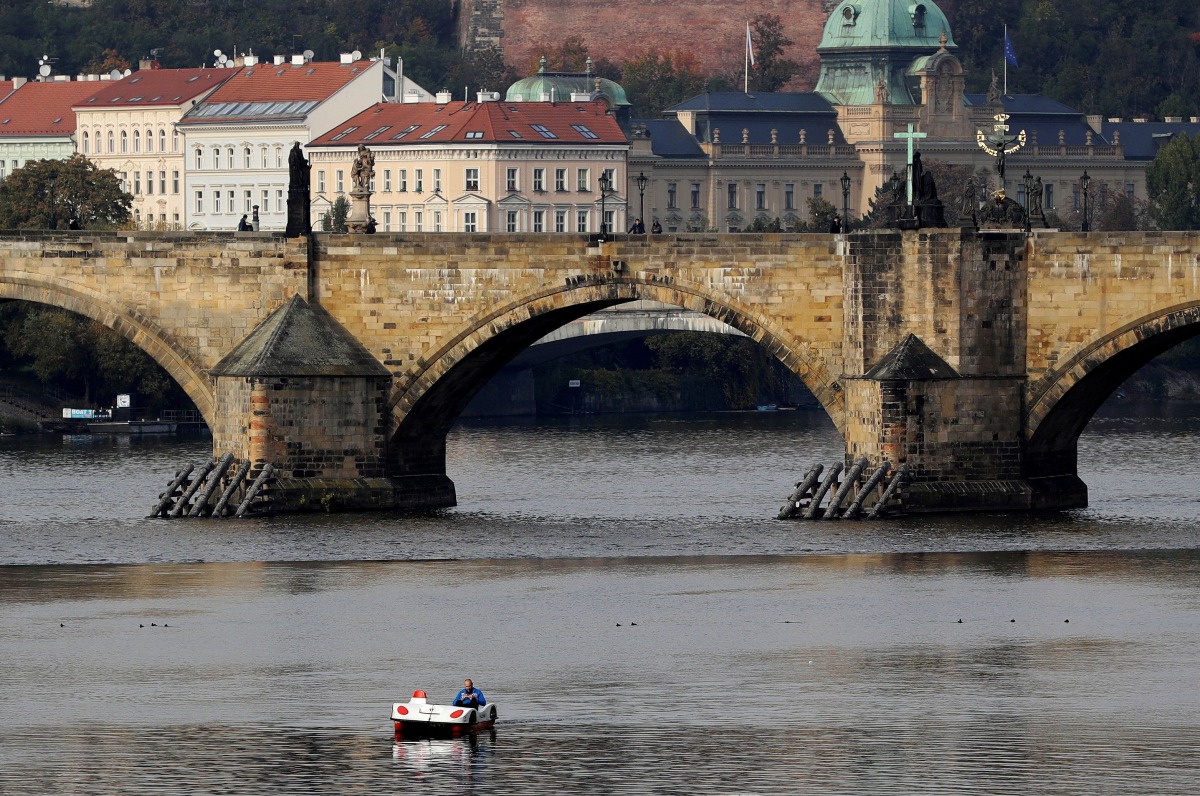 FILE PHOTO: A man rides a pedal boat on the Vltava river in Prague, Czech Republic, October 21, 2020. REUTERS/David W Cerny/File Photo
