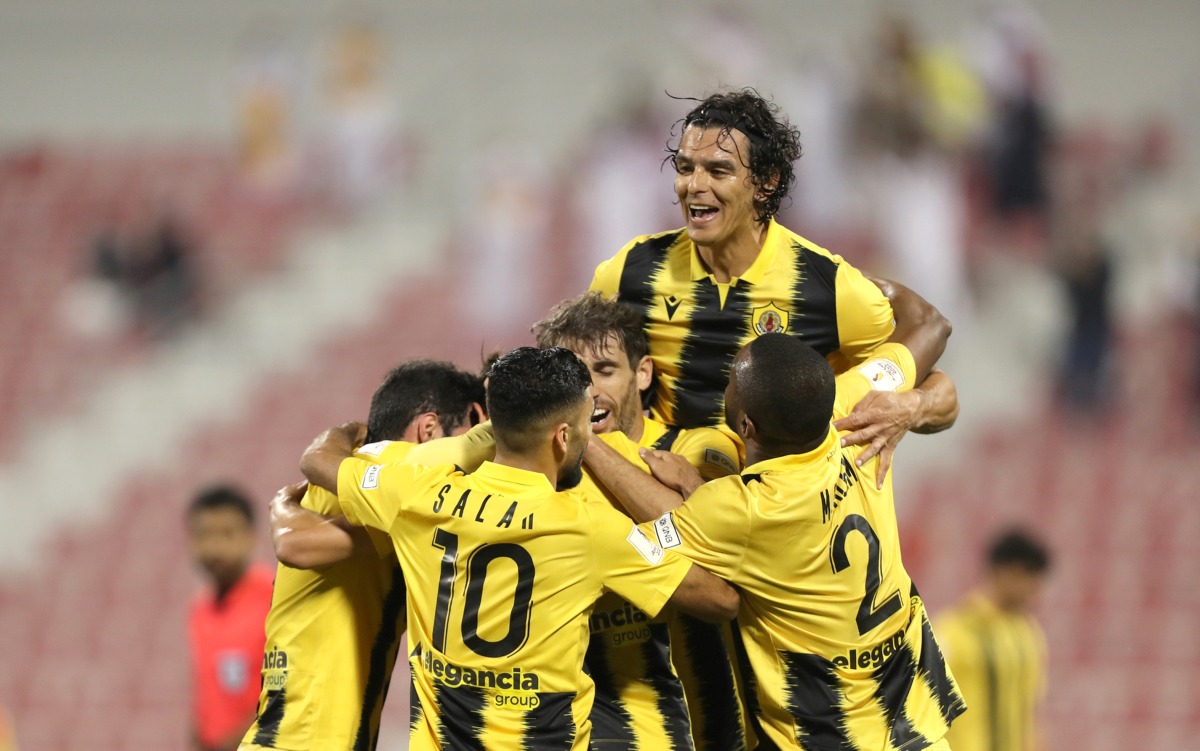 Qatar SC players celebrate after Bashar Rasan  scored their second goal.