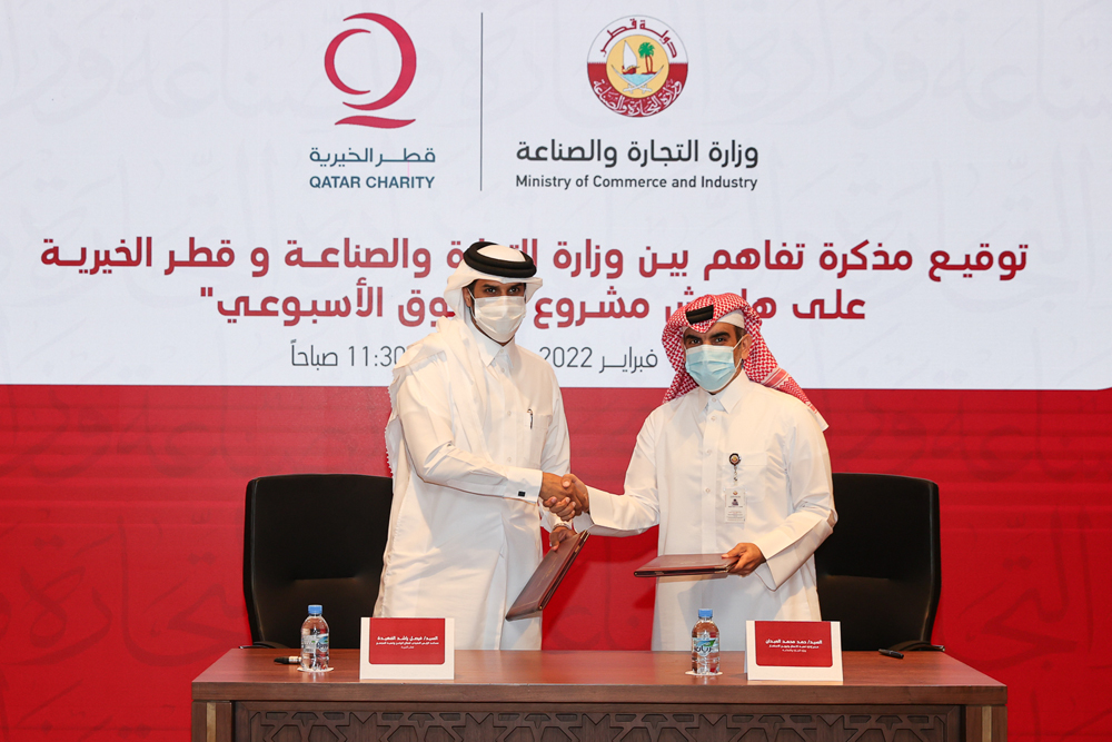  Hamad Mohammed Al Abdan and Faisal bin Rashid Al Fahida exchanging the signed documents.