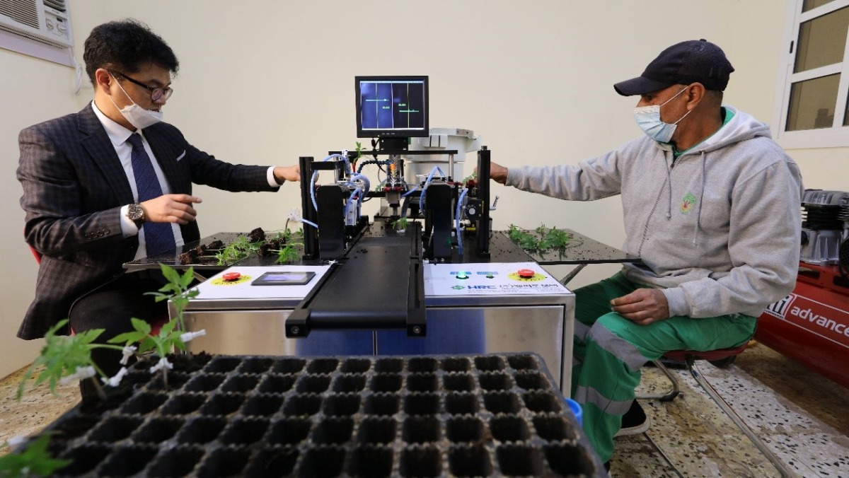 Officials with the automated grafting machine. 