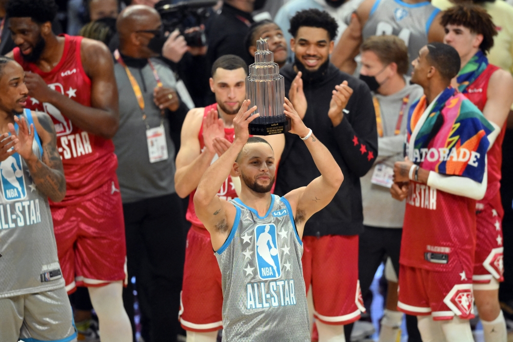 Team LeBron guard Stephen Curry (30) celebrates with a trophy for most valuable player after Team LeBron defeated Team Durant in the 2022 NBA All-Star Game at Rocket Mortgage FieldHouse. David Richard-USA TODAY Sports