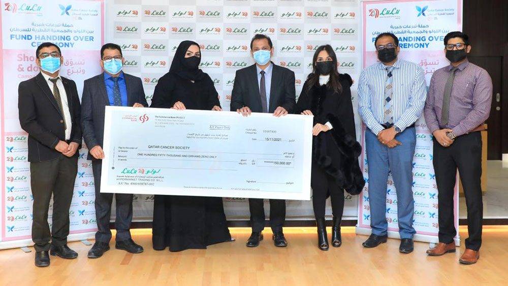 Officials from Lulu Hypermarket and Qatar Cancer Society during the fund hand over ceremony. 