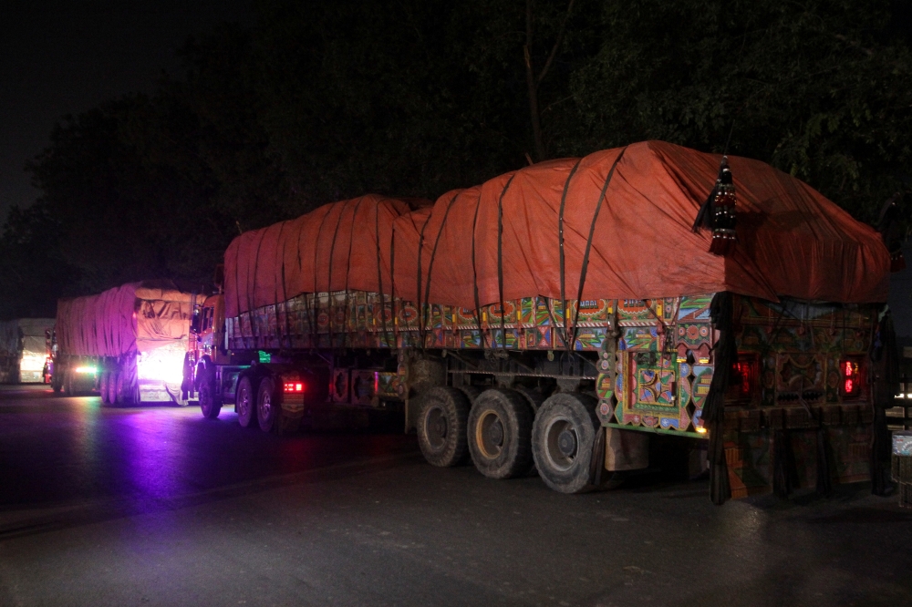 Supply trucks carrying aid shipments containing wheat to Afghanistan, move in a convoy near Lahore, Pakistan February 23, 2022. REUTERS.