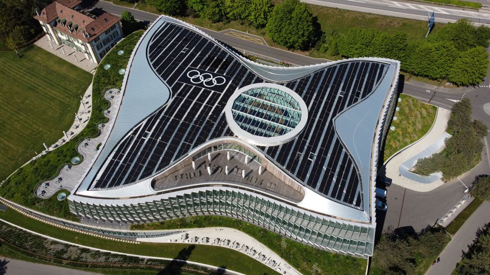 The Olympic rings are pictured among solar panels on top of the International Olympic Committee (IOC) headquarters in Lausanne, Switzerland, May 3, 2021. Picture taken with a drone. REUTERS/Denis Balibouse

