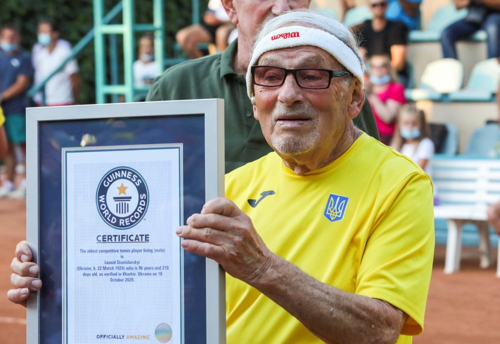 FILE PHOTO: The world's oldest tennis player Ukrainian Leonid Stanislavskyi, 97, takes part in an award ceremony of the Guinness World Record certificate in Kharkiv, Ukraine July 7, 2021. Picture taken July 7, 2021. REUTERS/Vyacheslav Madiyevskyy

