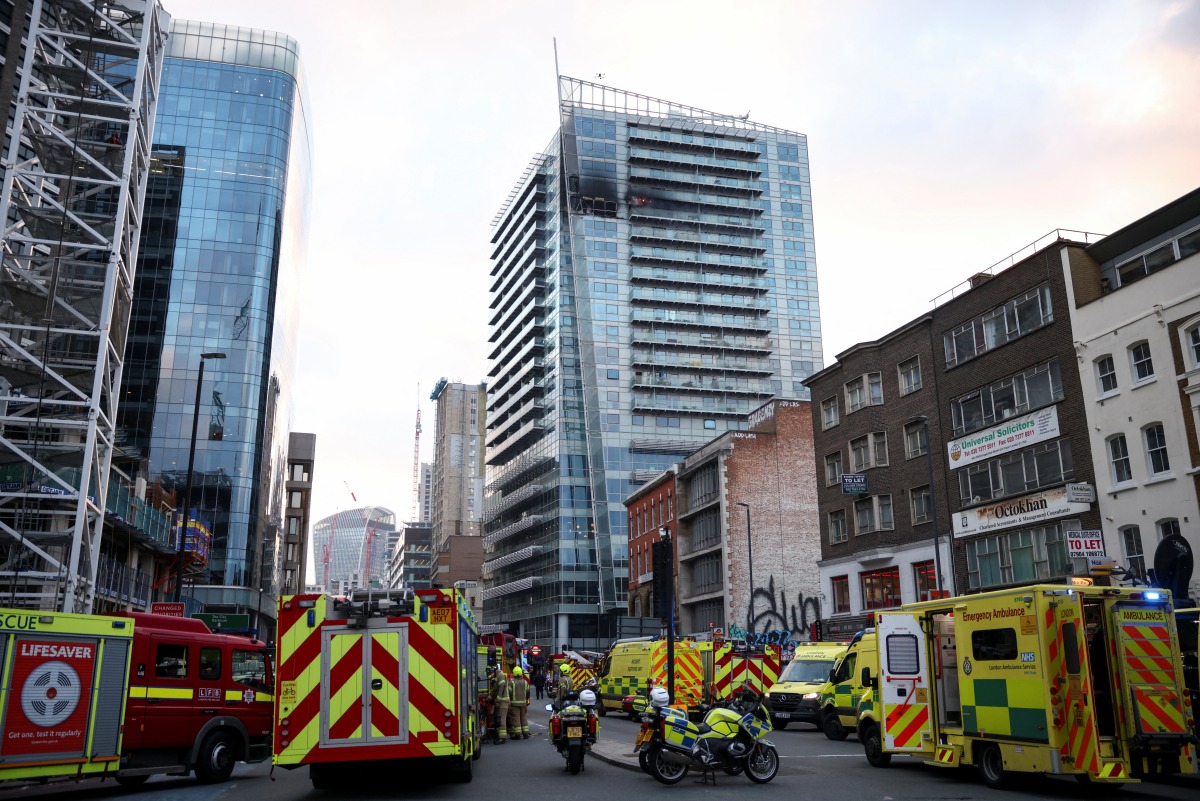 Emergency services' members work at a fire site in East London, Britain, March 7, 2022. REUTERS/Henry Nicholls
