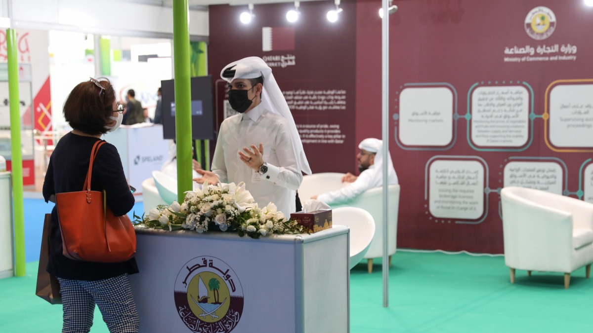 A visitor at the pavilion of Ministry of Commerce and Industry getting information about the initiatives by the Ministry to support Qatari products.