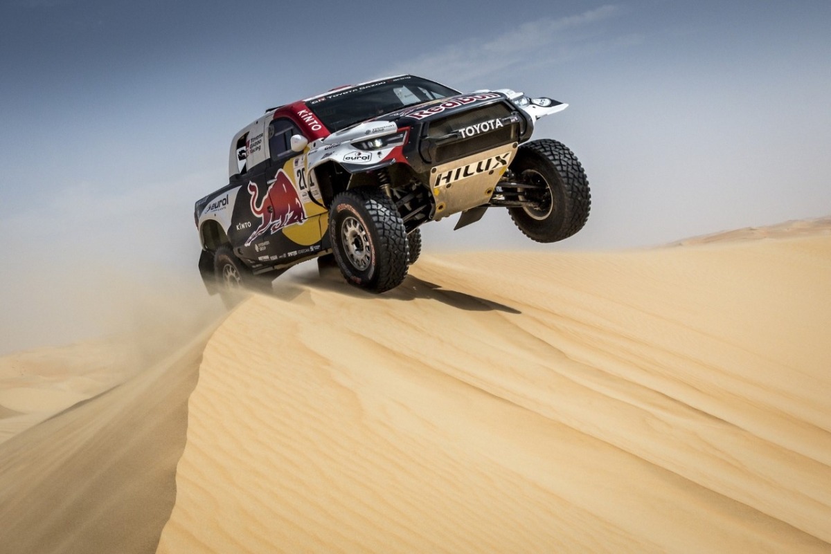 Nasser Saleh Al Attiyah in action during the Abu Dhabi Desert Challenge. RIGHT:  Nasser Saleh Al Attiyah and co-driver Mathieu Baumel at the presentation.