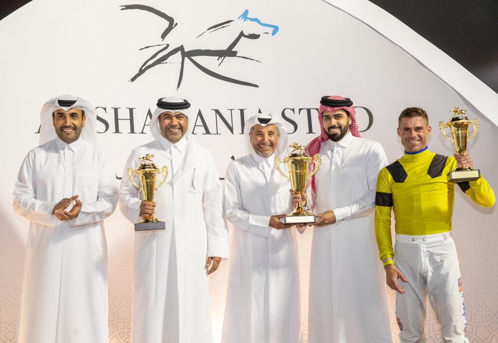 H H Sheikh Mohammed bin Khalifa Al Thani presents the trophy to Ibrahim Saeed Ibrahim Al Malki as QREC Chairman Issa bin Mohammed Al Mohannadi applauds following In The Night's triumph at QREC yesterday.