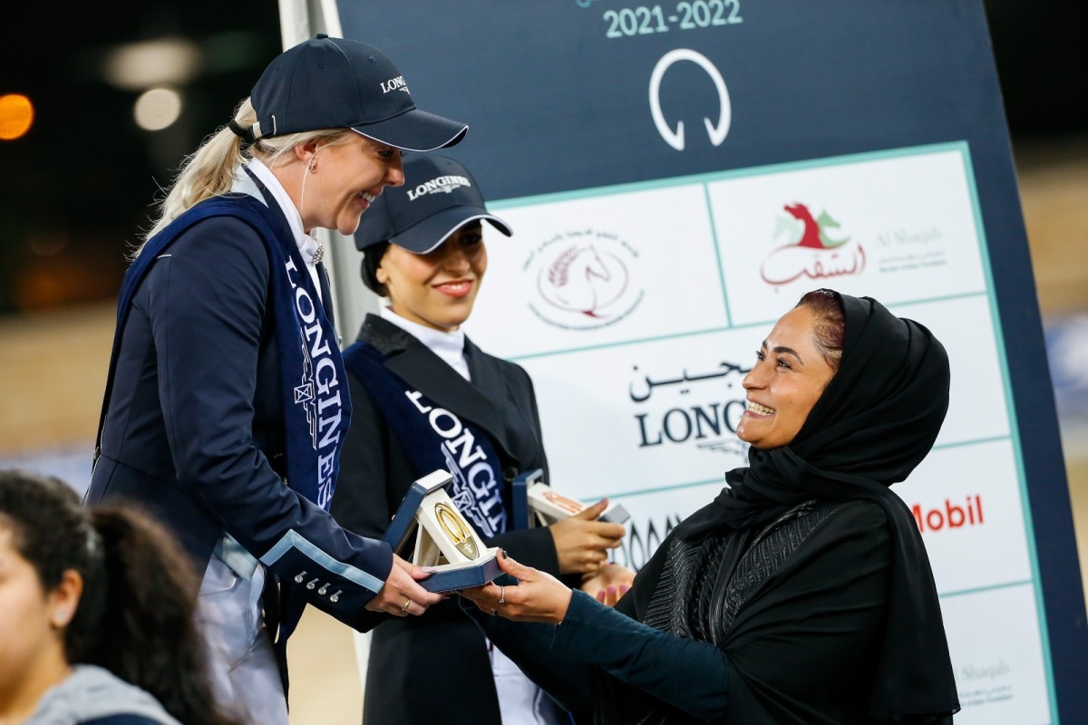 Qatar’s top dressage rider Wejdan Majed Al Malki presents a trophy to Jessica Waldon, who won the Medium Level 1 event in the final round of the Longines Hathab Dressage Tour yesterday.