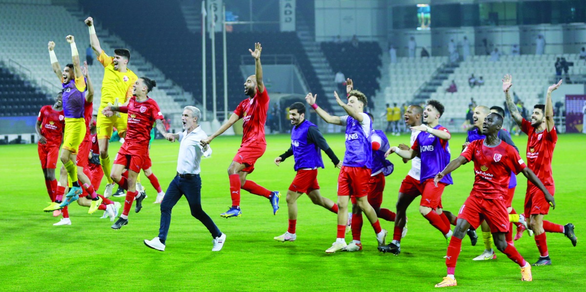 Al Duhail players celebrate with coach Luis Castro after defeating Al Sadd to reach the Amir Cup final, yesterday.