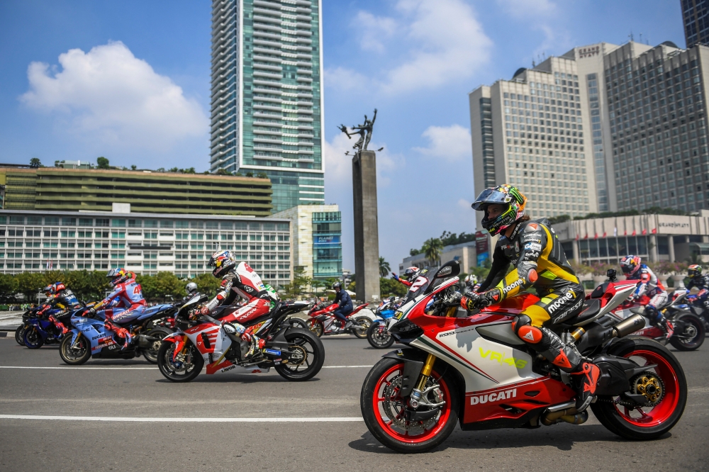 MotoGP racers ride passing the Bundaran Hotel Indonesia roundabout as they take part on a parade, ahead of the Indonesian Grand Prix that will be held this weekend at Pertamina Mandalika International Street Circuit on Lombok island, in Jakarta, Indonesia, March 16, 2022, in this photo taken by Antara Foto. Antara Foto/Galih Pradipta/via REUTERS