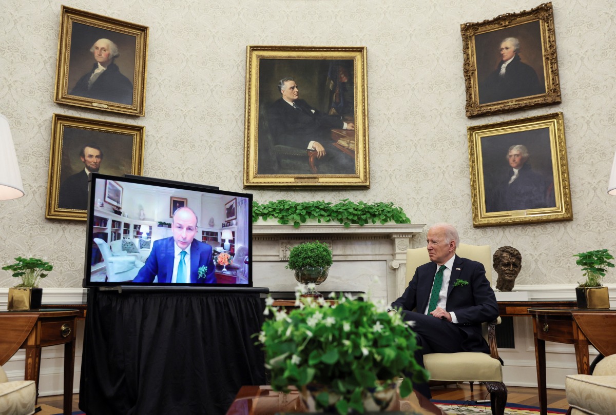 U.S. President Joe Biden hosts a virtual St. Patrick's Day visit with Ireland's Prime Minister Micheal Martin after Irish Taoiseach Martin tested positive for coronavirus disease (COVID-19) after arriving in Washington, in the Oval Office of the White House in Washington, U.S., March 17, 2022. REUTERS/Leah Millis
