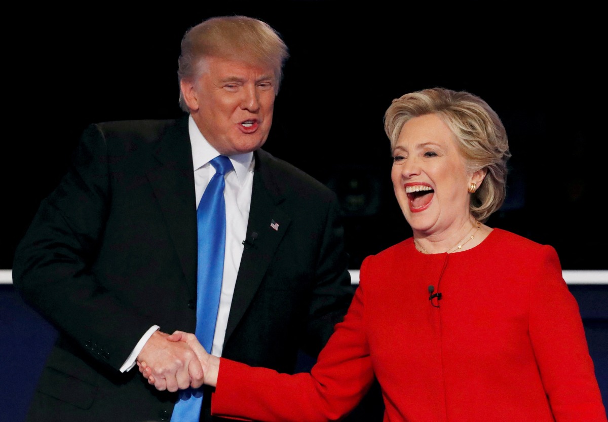 FILE PHOTO: Republican U.S. presidential nominee Donald Trump shakes hands with Democratic U.S. presidential nominee Hillary Clinton at the conclusion of their first presidential debate at Hofstra University in Hempstead, New York, U.S., September 26, 2016. REUTERS/Mike Segar/File Photo/File Photo
