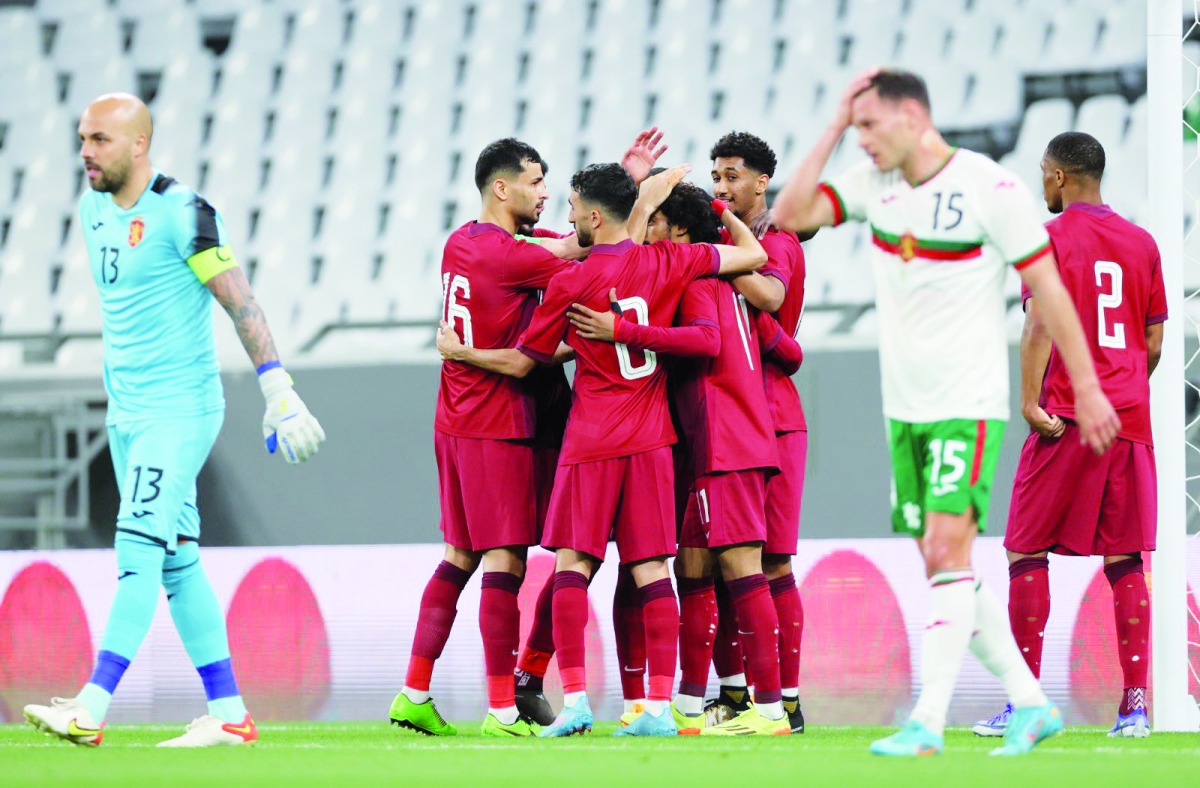 Qatar players celebrate their second goal yesterday.