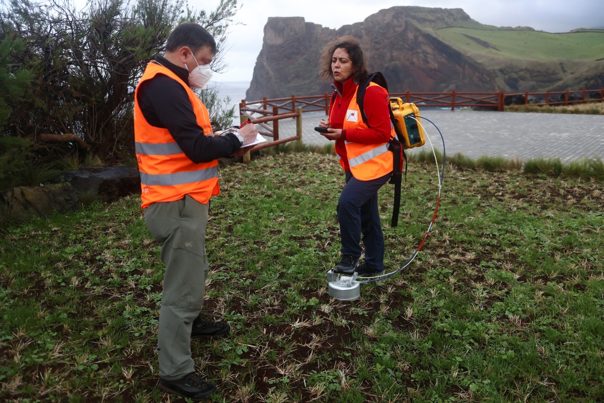 Vittoreo Zanon and Fatima Viveiros monitor soil gases in Rosais near Velas as small earthquakes have been recorded in Sao Jorge island, Azores, Portugal, March 27, 2022. REUTERS/Pedro Nunes
