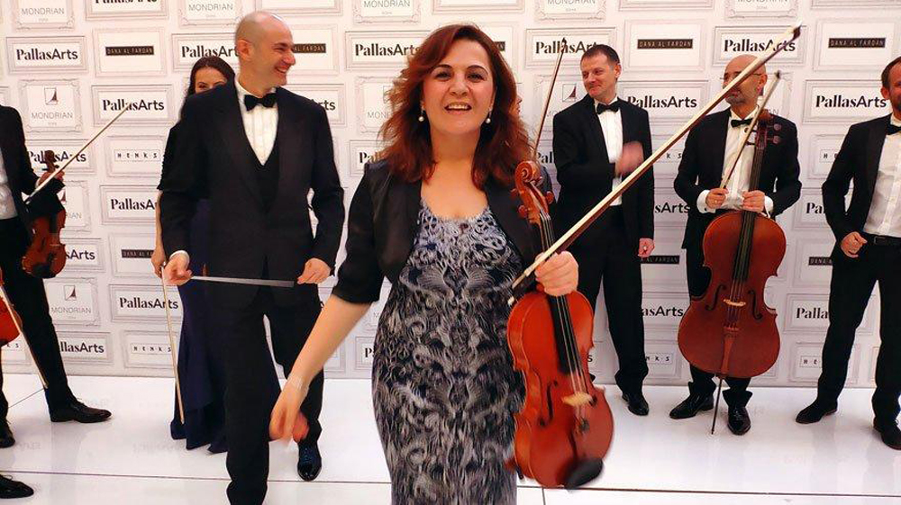 Merve Kenet Bulun with other QPO musicians.