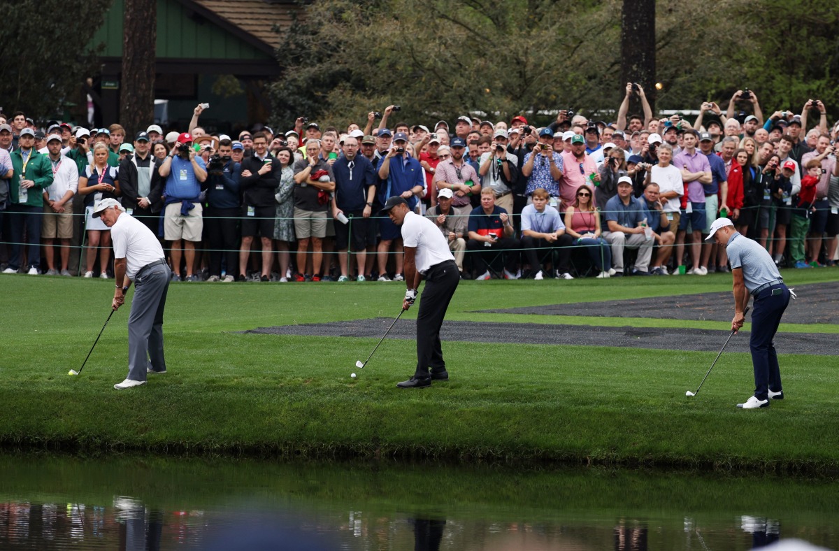  Tiger Woods, Justin Thomas and Fred Couples of the U.S. skim their shot on the water on the 16th during a practice round REUTERS/Mike Blake
