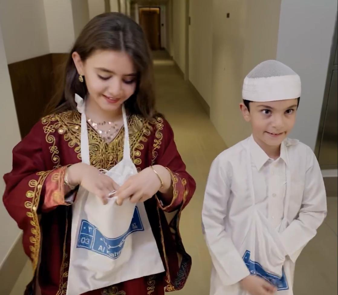 Kids in Garangao costumes collect goodies from neighbours at Msheireb Downtwon Doha.