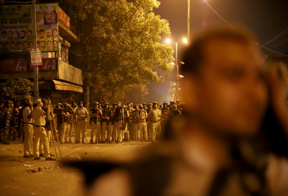 Police personnel stand guard after clashes broke out during a Hindu religious procession in Jahangirpuri area of New Delhi, India, April 16, 2022. Reuters/Stringer 