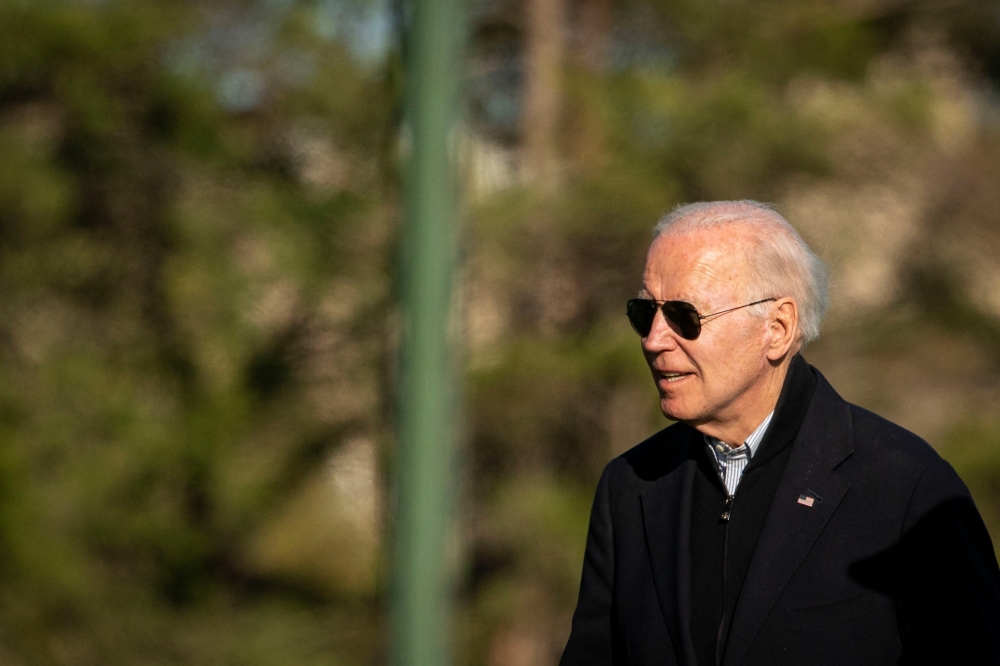 U.S. President Joe Biden walks towards his motorcade at Fort Lesley J. McNair, following spending the weekend at Camp David in Maryland, in Washington, U.S., April 17, 2022. REUTERS/Al Drago