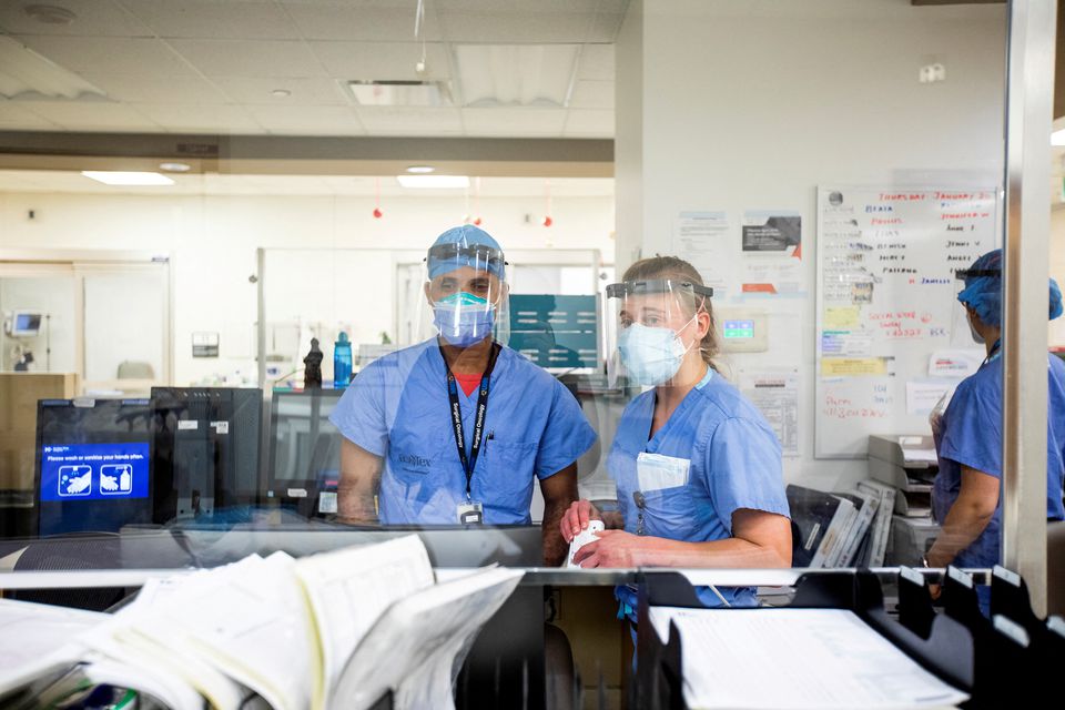 Emergency room nurse Janelle Van Halteren, right, speaks with her colleague as the Omicron coronavirus variant continues to put pressure on Humber River Hospital in Toronto, Ontario, Canada January 20, 2022. REUTERS/Carlos Osori

