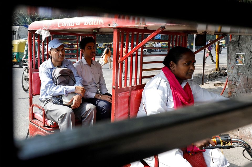 Binota Gayen, 45, rides an electric rickshaw carrying passengers in New Delhi, India, October 5, 2018. REUTERS/Anushree Fadnavis

