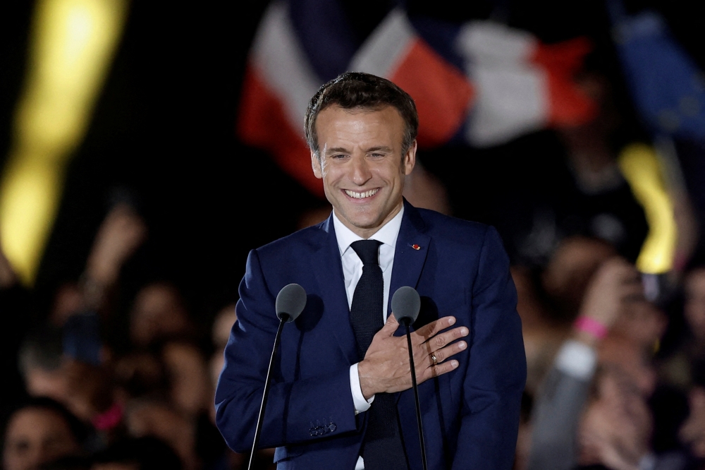 French President Emmanuel Macron gestures as he arrives to deliver a speech after being re-elected as president, following the results in the second round of the 2022 French presidential election, during his victory rally at the Champs de Mars in Paris, France, April 24, 2022. REUTERS/Benoit Tessier 