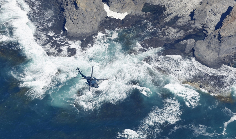 A helicopter searches for missing people onboard the tour boat 