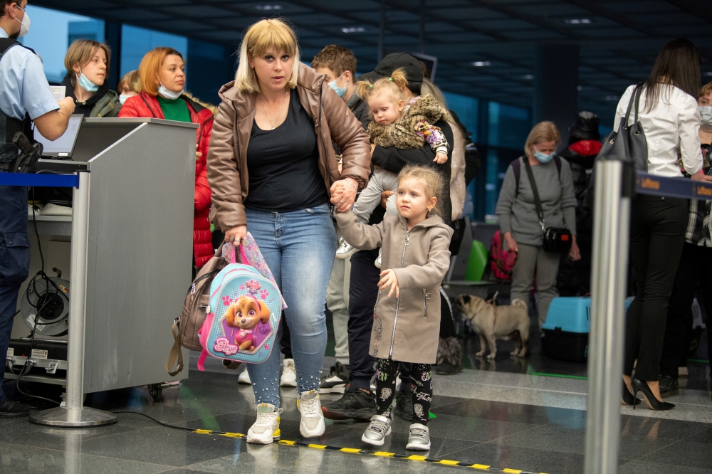 Ukrainian refugees who arrived in Germany with a first refugee plane from Moldova line up, after fleeing from Russia's invasion of Ukraine, at the international airport of Frankfurt, Germany, March 25, 2022. Boris Roessler/Pool via REUTERS/File Photo