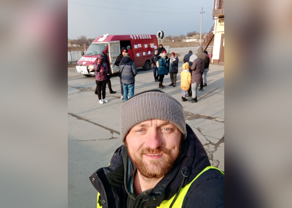 Mykhailo Puryshev poses for a selfie photo in front of a car as he evacuates people fleeing Russia's invasion of Ukraine, in Zaporizhzhia, Ukraine, in this undated handout photo obtained by Reuters on April 26, 2022. Courtesy of Mykhailo Puryshev/Handout via REUTERS