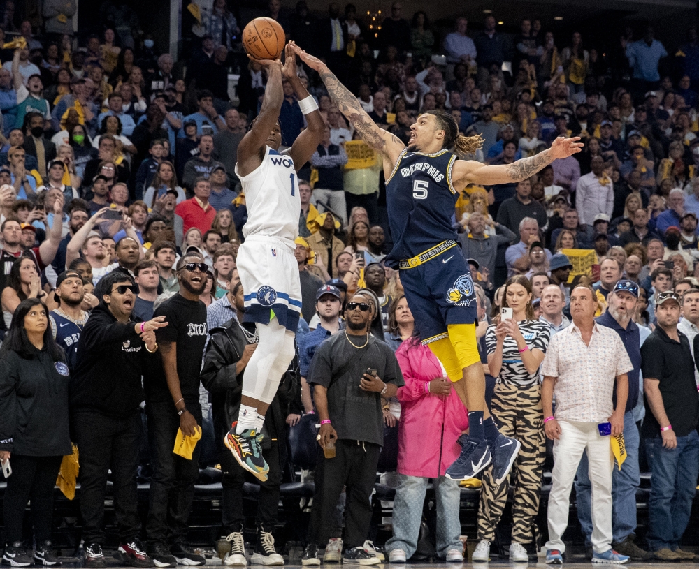 Minnesota Timberwolves forward Anthony Edwards (1) shoots a three-point field goal while guarded by Memphis Grizzlies forward Brandon Clarke (15) in game five of the first round for the 2022 NBA playoffs at FedExForum.  Christine Tannous 