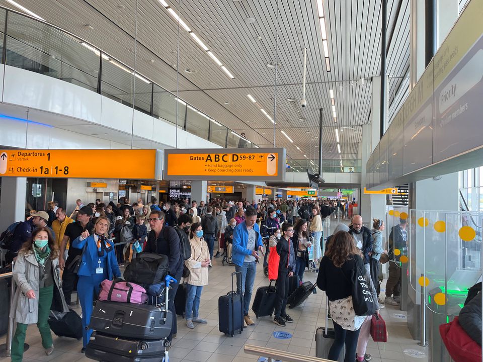 FILE PGOTO: Travellers wait in lines at Amsterdam Schiphol Airport as an unannounced strike of ground staff caused many delays and cancellations, in Amsterdam, Netherlands April 23, 2022. REUTERS/Anthony Deutsch/File Photo
