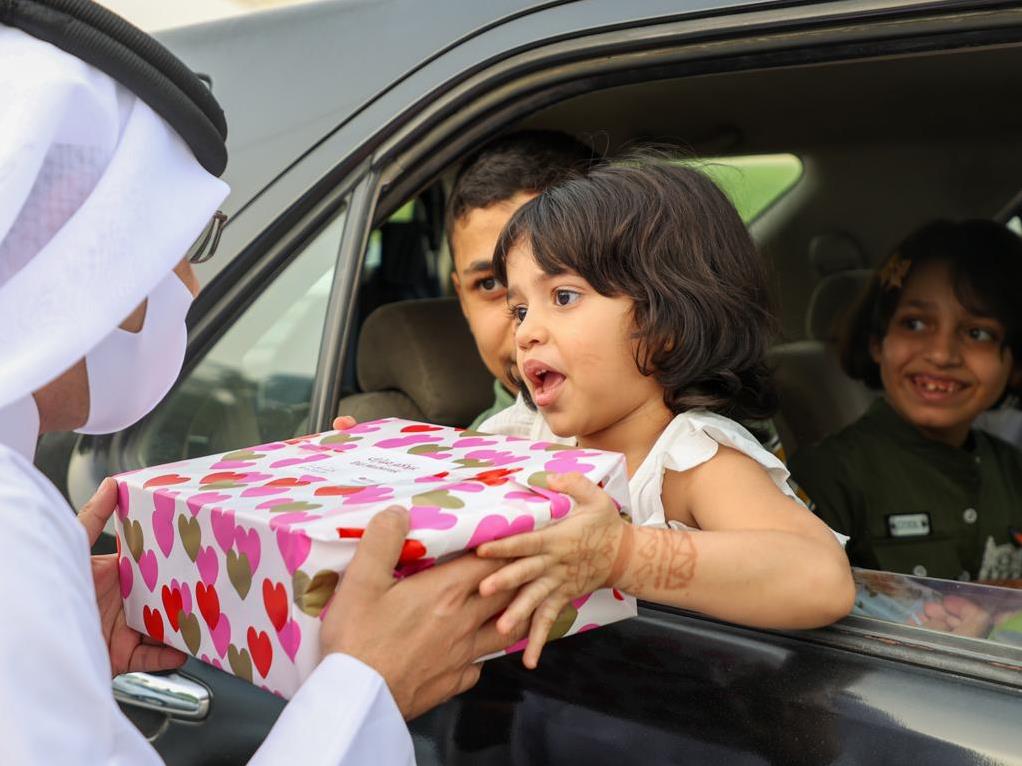 An official distributing Eid gift.