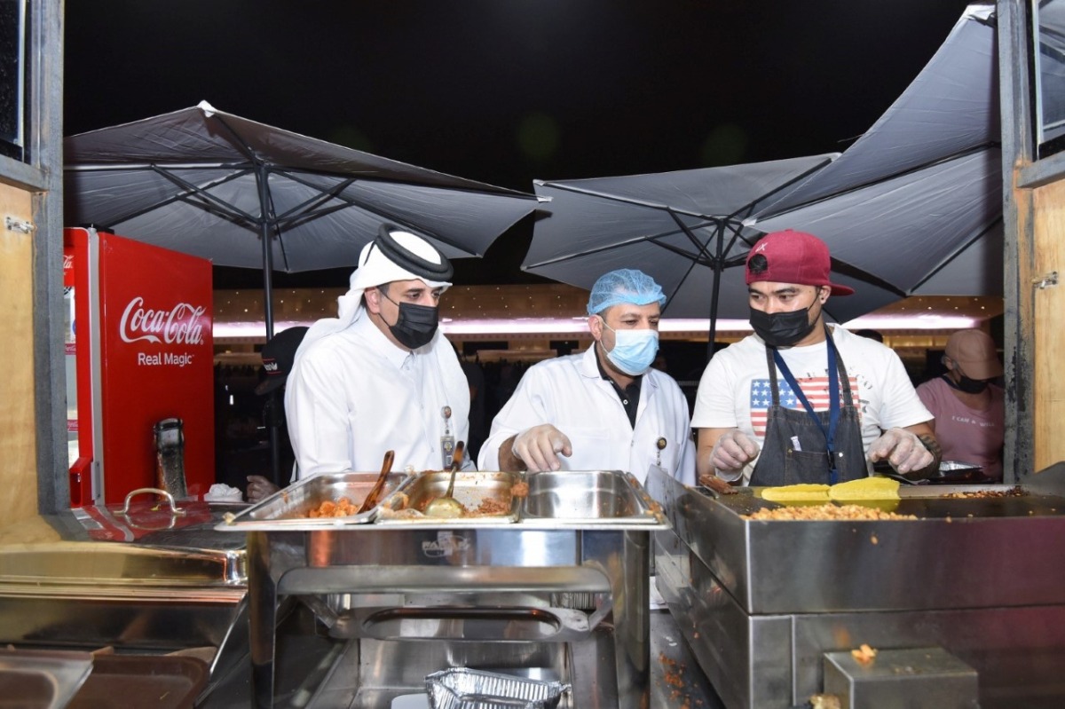 Municipal officials inspecting a food kiosk during the Eid Festival at Doha Corniche. 