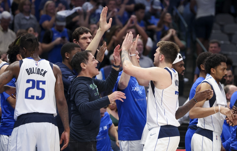 Dallas Mavericks guard Luka Doncic (77) celebrates with owner Mark Cuban and teammates after leaving the game during the fourth quarter against the Phoenix Suns in game three of the second round of the 2022 NBA playoffs at American Airlines Center.  Kevin Jairaj