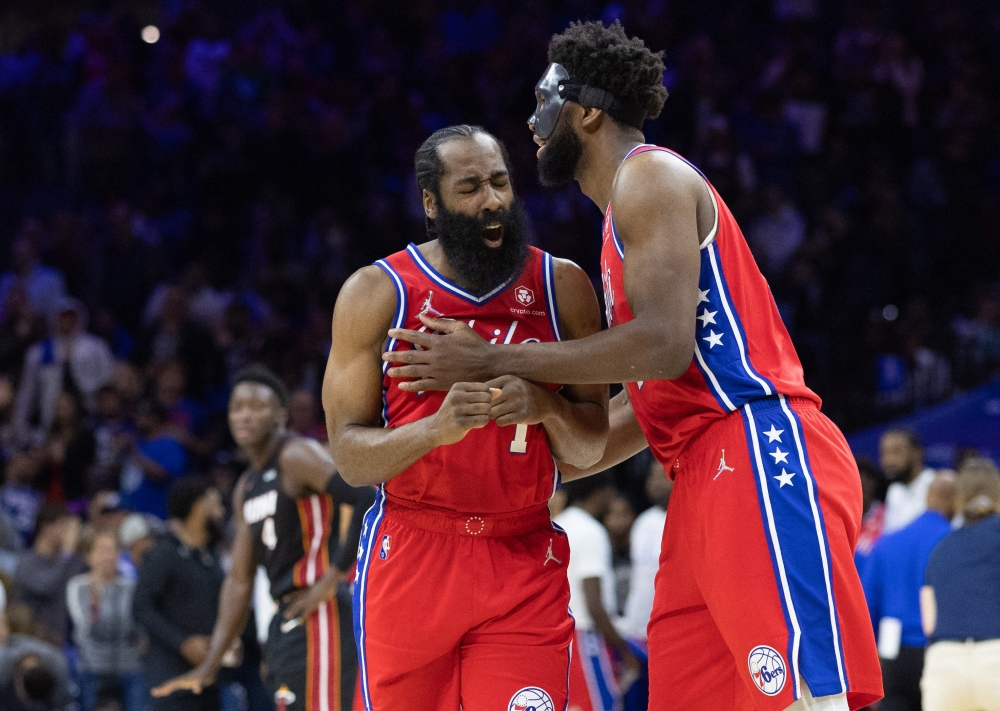 Philadelphia 76ers guard James Harden (1) reacts with center Joel Embiid (21) after a score against the Miami Heat during the second quarter in game four of the second round for the 2022 NBA playoffs at Wells Fargo Center. Bill Streicher 