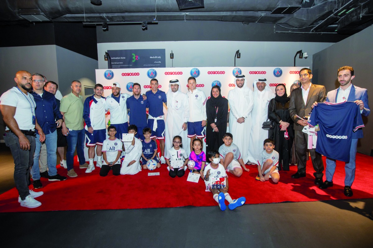 Paris Saint-Germain (PSG) players with Ooredoo officials and fans.