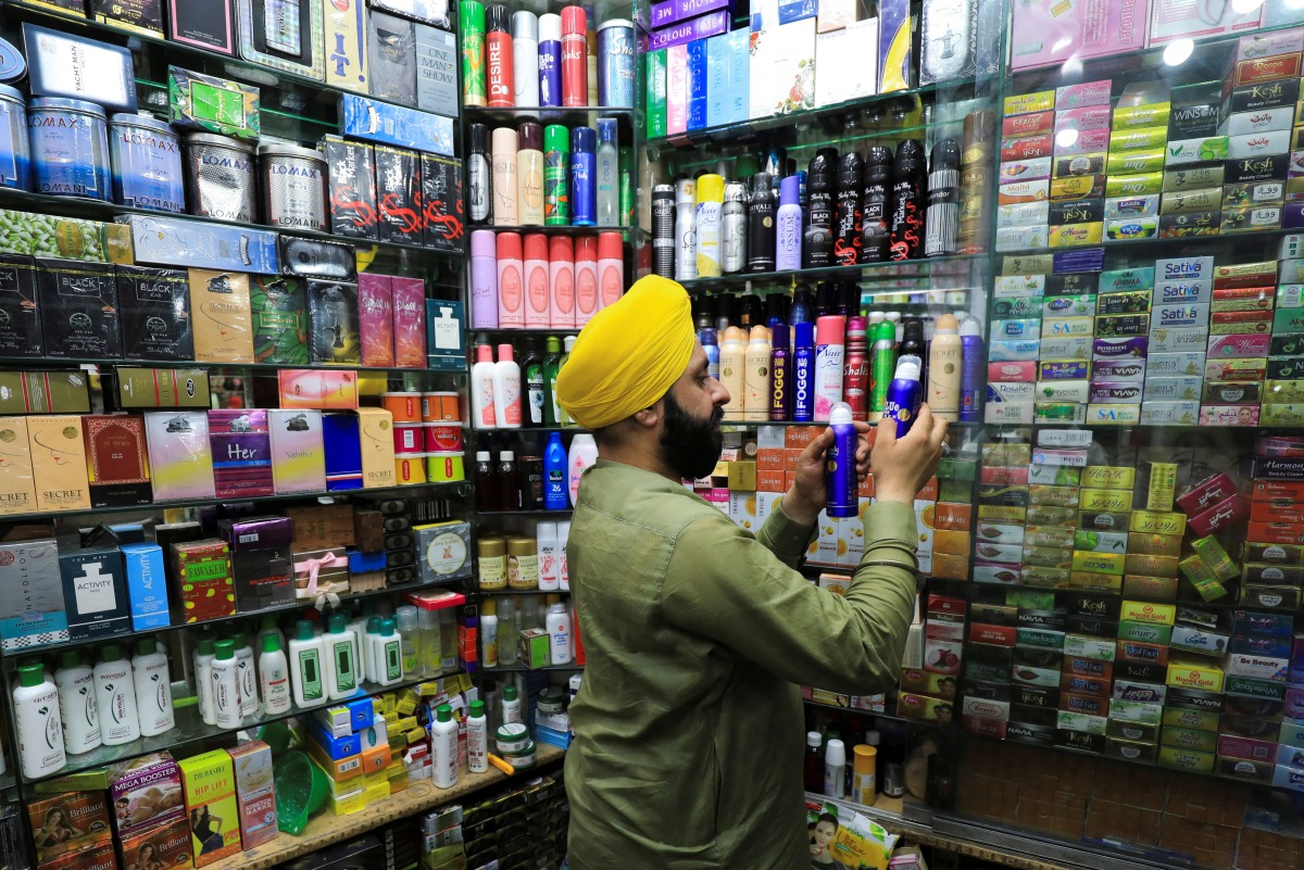 A shopkeeper arranges spray perfumes in a showcase at his shop in Peshawar, Pakistan, May 19, 2022. REUTERS/Fayaz Aziz
