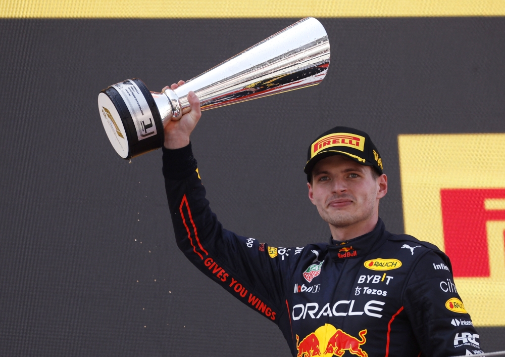 First placed Max Verstappen of Red Bull celebrates with his trophy on the podium after the race REUTERS/Albert Gea
