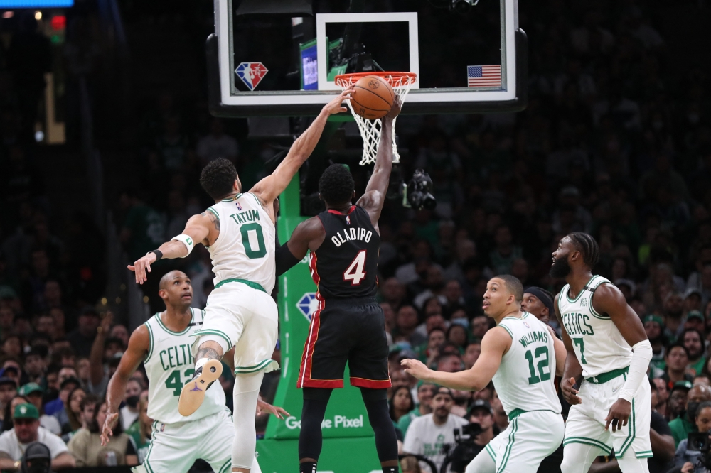 Miami Heat guard Victor Oladipo (4) goes to the basket defended by Boston Celtics forward Jayson Tatum (0) in the second half during game four of the 2022 eastern conference finals at TD Garden.Paul Rutherford